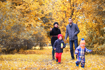 Family in autumn park in the afternoon