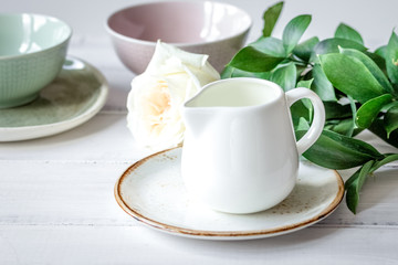 ceramic tableware with flowers on white background