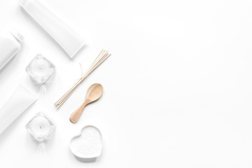 white set of cosmetics for spa on table background top view mock