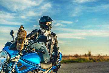 Man on sport motorcycle outdoor on the road