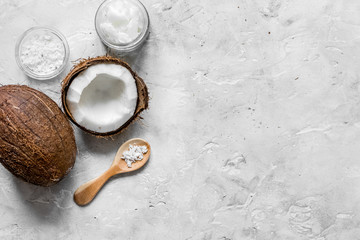 fresh coconut with cosmetic oil in jar on gray background top vi