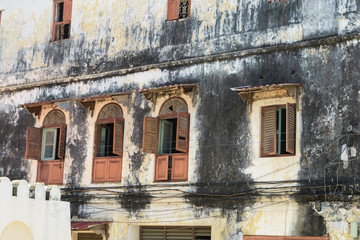 Fototapeta na wymiar Old shabby house in Stone Town, Tanzania, Zanzibar