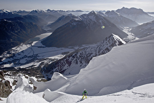 Snowboarder riding in deep powder snow, Thaneller, Tyrol, Austria