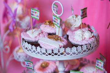 Candy bar. Banquet table full of desserts and an assortment of sweets. pie and cake. Pink pastry