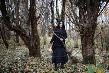 A woman in a witch suit in a forest