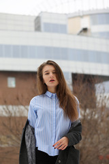 Young adult girl in coat on the street