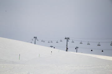 Snowboarder downhill on off piste slope with newly-fallen snow. Caucasus Mountains, Georgia, ski resort Gudauri.
