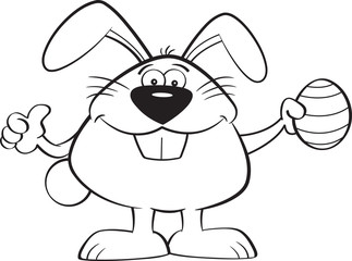 Black and white illustration of the Easter bunny holding an Easter egg and giving thumbs up.