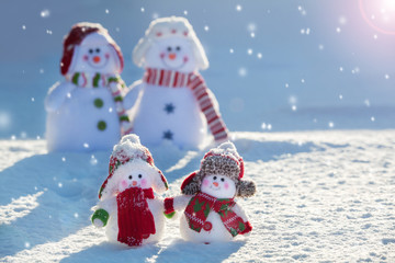 Family snowmans on snow