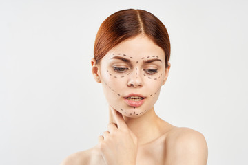 Naklejka premium Young beautiful woman on a light background, contour, plastic facial surgery, portrait