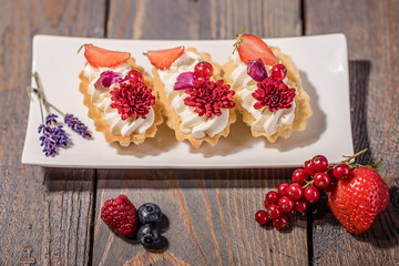 close up of a cream cake decorated with edible flowers
