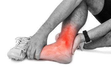 Highlighted leg of injured man against white background