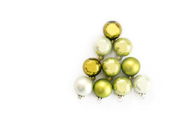 Green Christmas balls in the shape of a fir tree isolated with shadows on a white background, greeting card, flat top view from above, copy space
