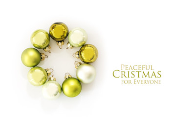 Green Christmas balls in a circle isolated with shadows on a white background, text Peaceful Christmas for everyone, flat top view from above, copy space