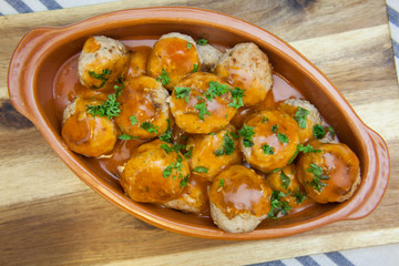 Homemade meatballs in tomato sauce with parsley. Top view