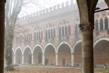 Fototapeta premium Pavia, Italy. November 11 2017. Castello Visconteo (Visconteo castle) on a foggy day.