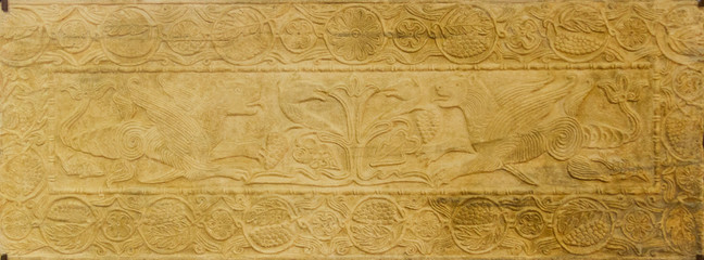 Pavia, Italy. November 11 2017. The tree of life and winged dragons around it. Marble plate....