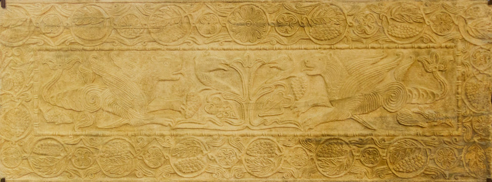 Pavia, Italy. November 11 2017. The tree of life and winged dragons around it. Marble plate. Castello Visconteo (Visconteo Castle) in Pavia.