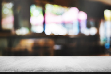 empty wooden table in front of blur coffee shop cafe or restaurant background