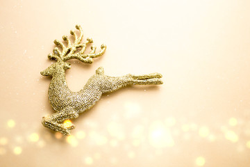 golden glitter reindeer with bokeh in christmas concept