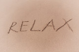 Relax Sign on a Yellow Sand Beach.