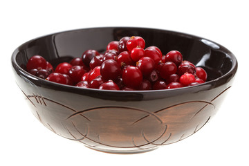 cranberries in a clay bowl isolated on white background