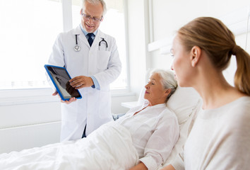 Fototapeta premium senior woman and doctor with tablet pc at hospital