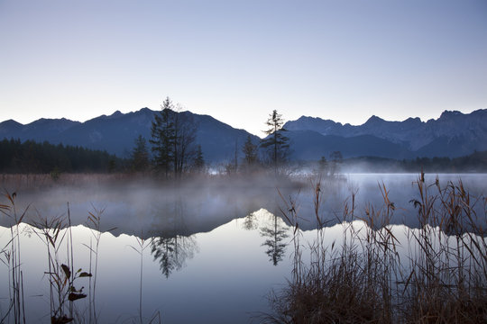 Morning mist over Barmsee lake, Bavaria, Germany