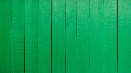 Wooden fence painted in green, texture.