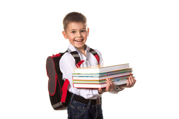 Smiling school boy with backpack holding notebooks, on white background