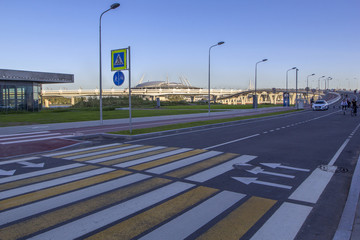 Pedestrian road with a painted zebra, pedestrian crossing on the Yacht Bridge, new stadium "Zenith Arena",  Krestovsky island in St. Petersburg
