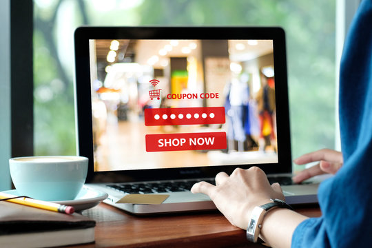 Woman typing discount coupon code on laptop screen to get the shopping on line promotion, on line shopping ,digital marketing business and technology, lifestyle concept