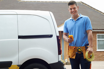 Portrait Of Electrician With Van Outside House
