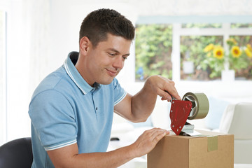 Man At Home Sealing Box For Dispatch