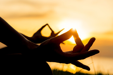 Close up hands. Woman do yoga outdoor. Woman exercising vital and meditation for fitness lifestyle...