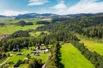 Obraz premium Slovakian town Stara Lubovna on forested hillside. beautiful rural scenery in mountainous area viewed from above on a summer day. 