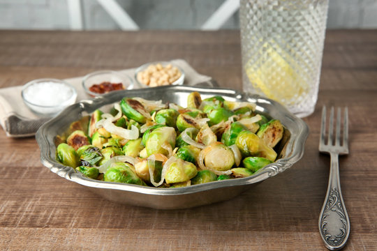 Metal plate with roasted brussel sprouts on table