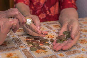 Old people often have financial problems. You have to count on every penny. Hands of an old woman (65-80 years) with the wherewithal. Concept: Money (EURO)