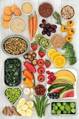 Vegetarian super food concept of fresh fruit, vegetables, cereals, grains, pulses, herbs and spice. Health food with foods high in antioxidants, minerals, fibre, smart carbohydrates and protein.