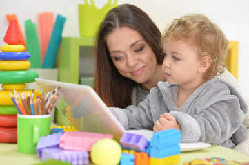 mother and daughter using laptop