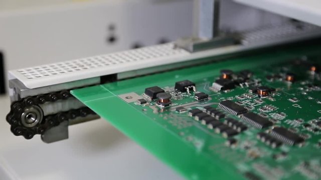 Insertion of electronic components on printing circuit board assembly before wave soldering.  High tech electronic pcb printed circuit board with processor and microchips.