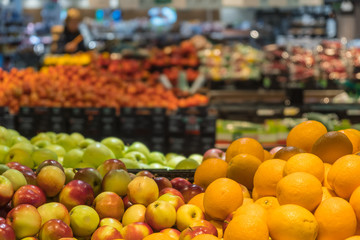 Fruit department in the supermarket. Oranges and apples