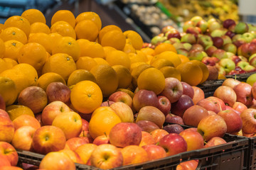 Fruit department in the supermarket. Oranges and apples