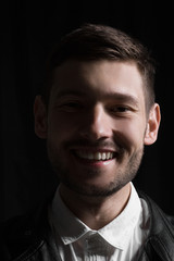 Male portrait in leather jacket in studio
