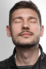 Obraz premium Male portrait in leather jacket in studio