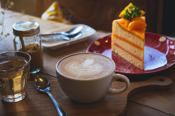 coffee aroma cup and tasty cake fruit on wood table in cafe coffee shop vintage style