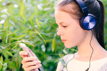 Cute girl listening to music with headphones outdoor