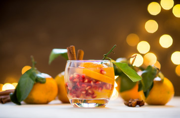 Homemade sangia with tangerines and pomegranate on the rustic background. Selective focus. Shallow depth of field.