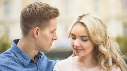 Man looking at beautiful young woman passionately, romantic relationship, date