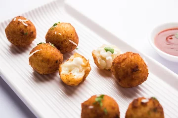 Poster Fried potato cheese balls or croquettes with tomato ketchup. Selective focus   © StockImageFactory